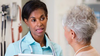 Nurse speaking to older patient