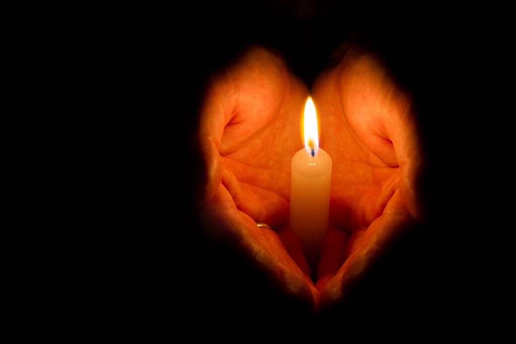 Man hands holding a burning candle
