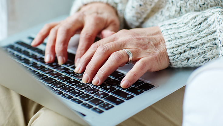 older adult chatting on computer