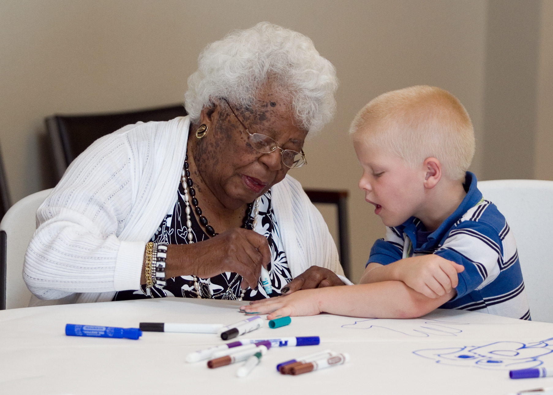 Senior woman drawing with child